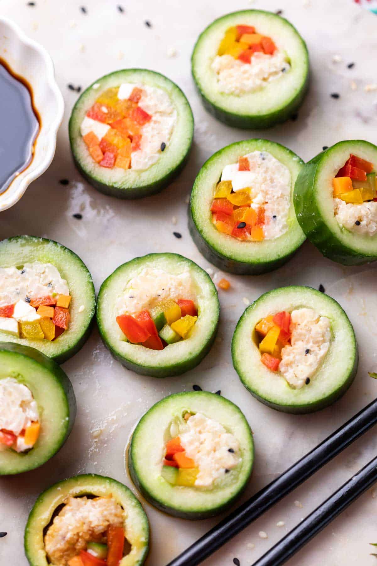 cucumber sushi served with chopsticks and soy sauce