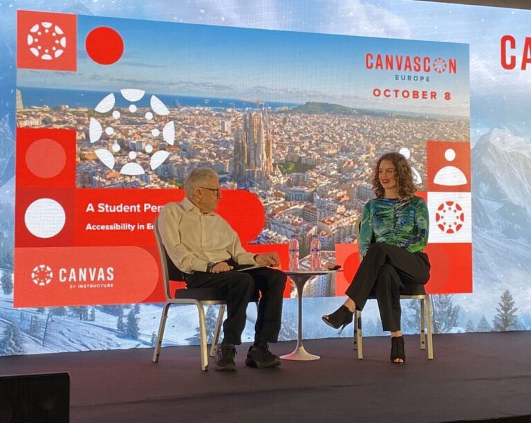 Two panellists talking at a conference on stage.